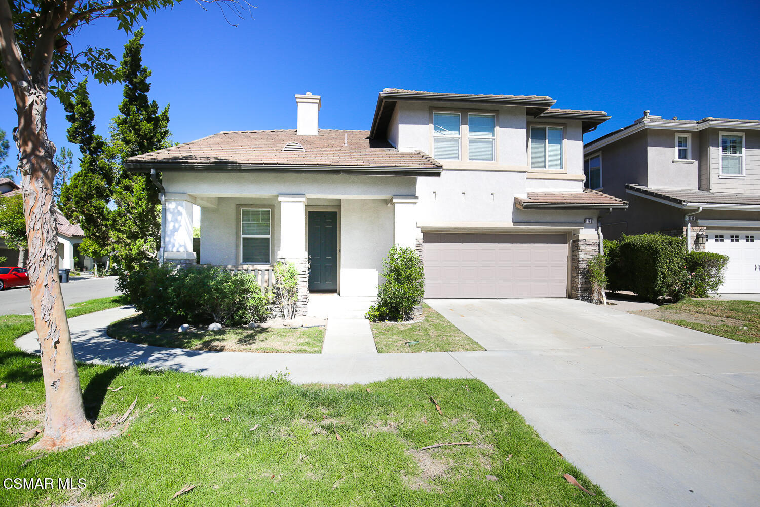1129 Azalea Way Simi Valley, CA 93065 - Photo 3 of 50 a front view of a house with a yard and garage