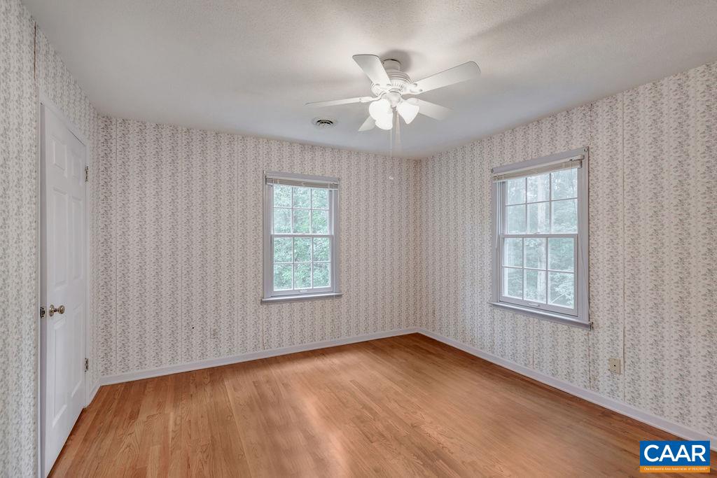 4875 Mechunk Road Keswick, VA 22947 - Photo 15 of 38 a view of an empty room with a window and wooden floor