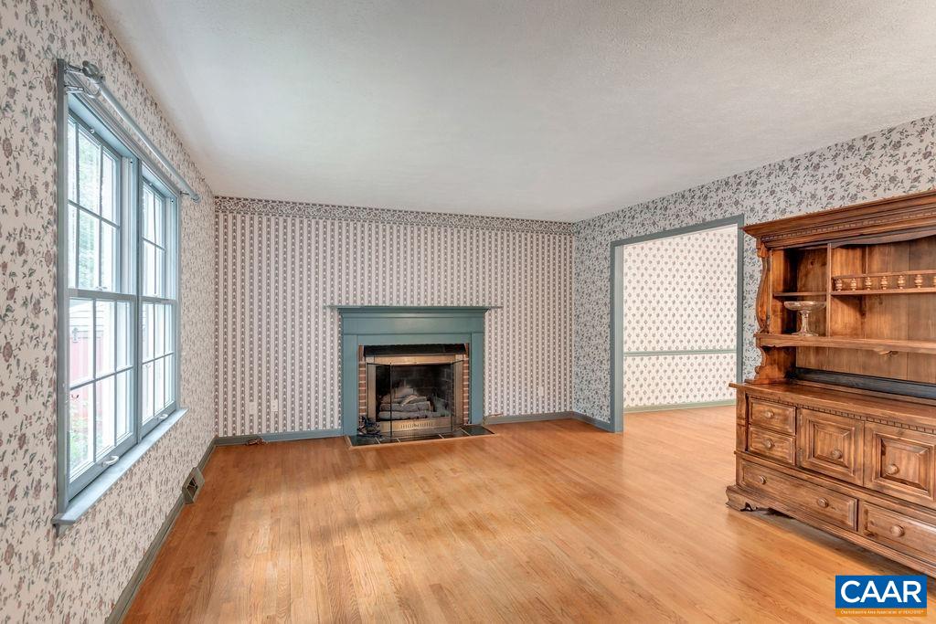 4875 Mechunk Road Keswick, VA 22947 - Photo 3 of 38 a view of an empty room with a fireplace and a window