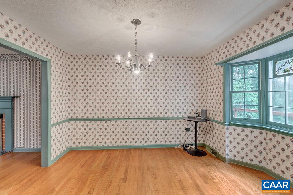 4875 Mechunk Road Keswick, VA 22947 - Photo 6 of 38 a view of a livingroom with wooden floor and a ceiling fan