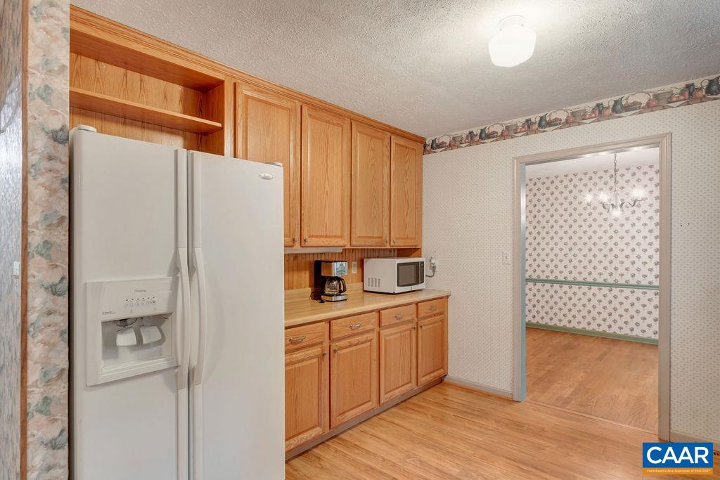4875 Mechunk Road Keswick, VA 22947 - Photo 8 of 38 a kitchen with white cabinets and white appliances
