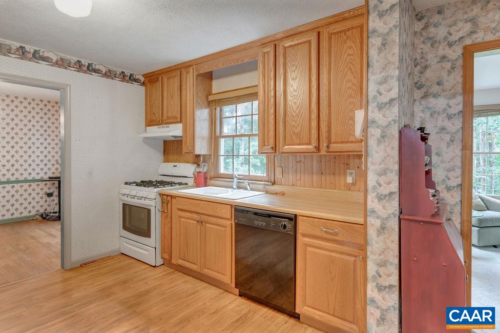 4875 Mechunk Road Keswick, VA 22947 - Photo 9 of 38 a kitchen with a sink stove and cabinets