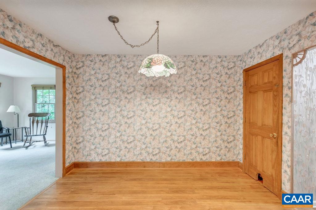 4875 Mechunk Road Keswick, VA 22947 - Photo 10 of 38 a view of a livingroom with wooden floor and a chandelier