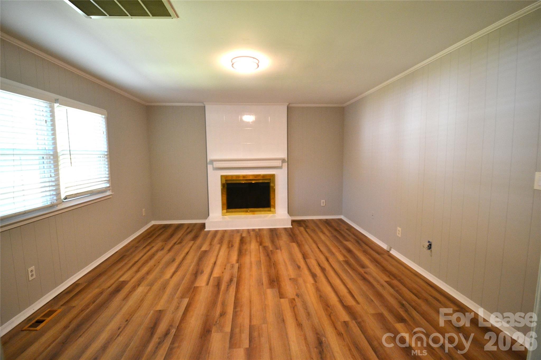 1422 Thermal Road Charlotte, NC 28212 - Photo 7 of 40 a view of empty room with wooden floor and fireplace