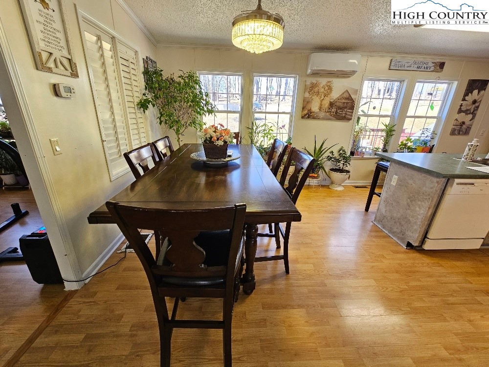 8863 Glade Valley Road Ennice, NC 28623 - Photo 12 of 31 a view of a dining room with furniture and a chandelier