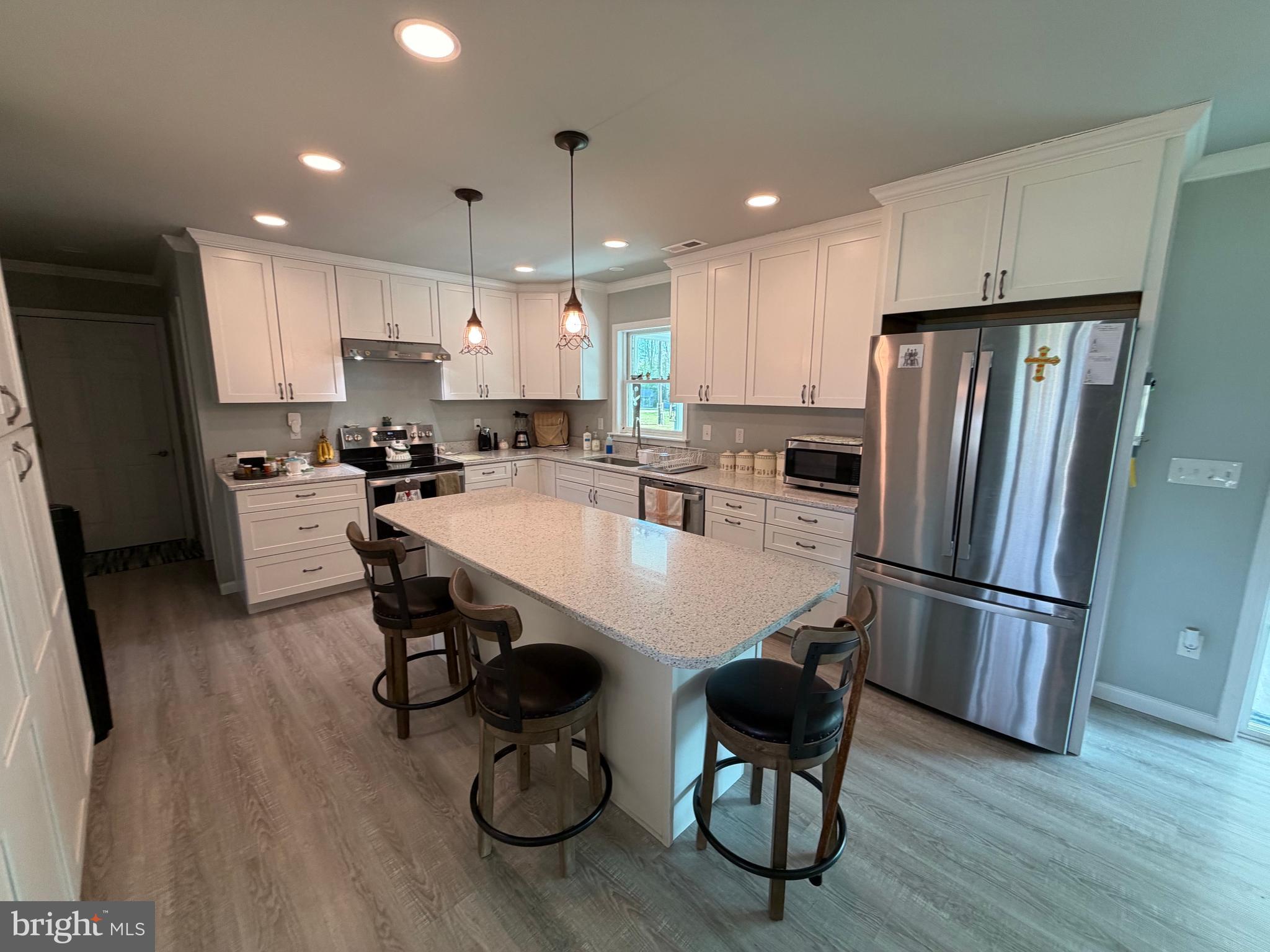 36032 Double Bridges Road Frankford, DE 19945 - Photo 21 of 51 a kitchen with refrigerator and wooden floor