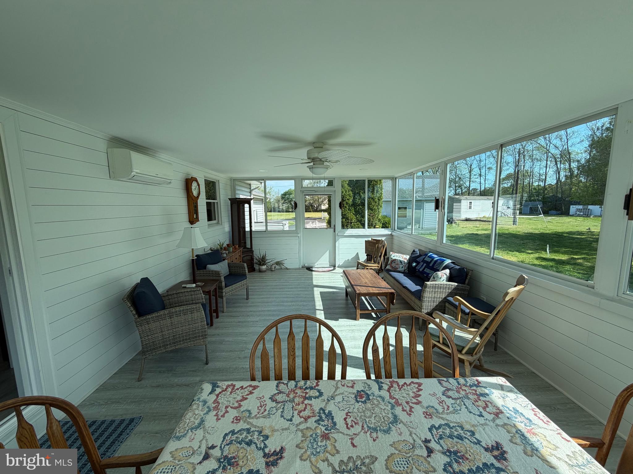 36032 Double Bridges Road Frankford, DE 19945 - Photo 49 of 51 a view of a dining room and livingroom with furniture wooden floor and a rug