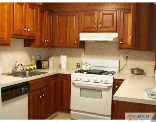 47 Inverness Terrace Fords, NJ 08863 - Photo 3 of 10 a kitchen with a sink stove and cabinets