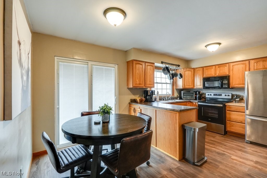 3204 Old Forge Road Kent, OH 44240 - Photo 19 of 42 Kitchen featuring sink, light hardwood / wood-style floors, and appliances with stainless steel finishes