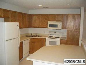 16836 Timber Crossing Road Charlotte, NC 28213 - Photo 2 of 6 a kitchen with a refrigerator sink and stove