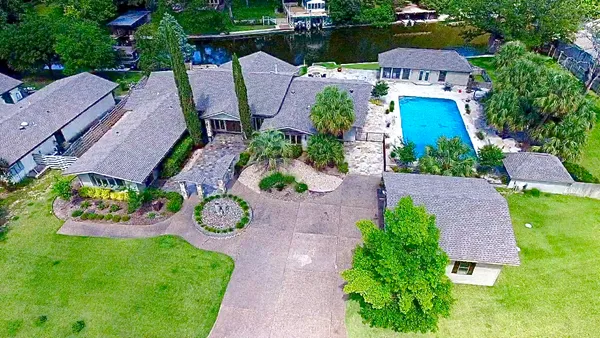 an aerial view of a house with garden space and street view
