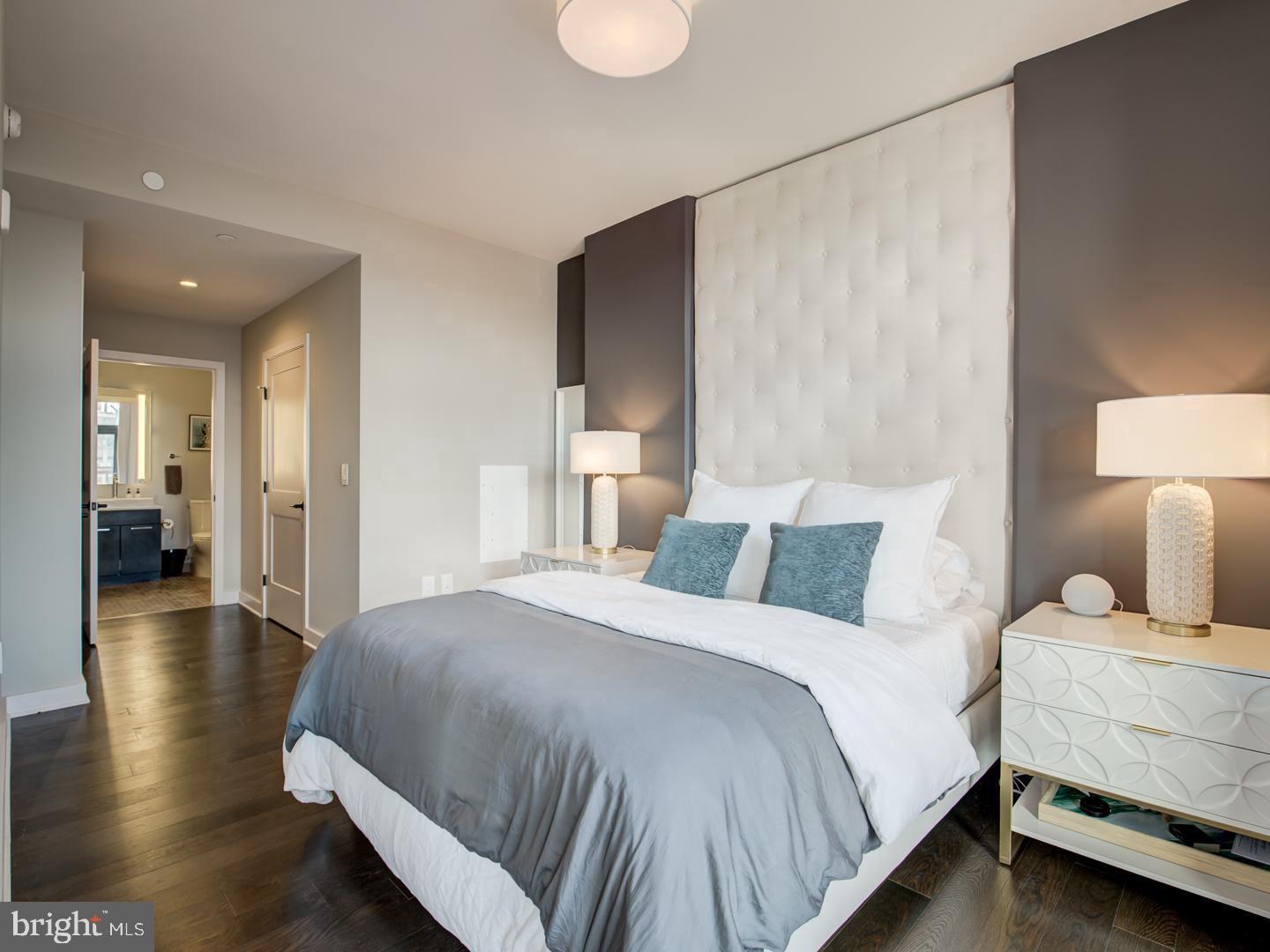 a bedroom with a bed and a lamp