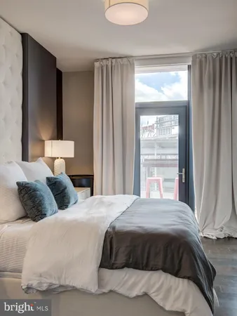 a bedroom with a bed and a night stand