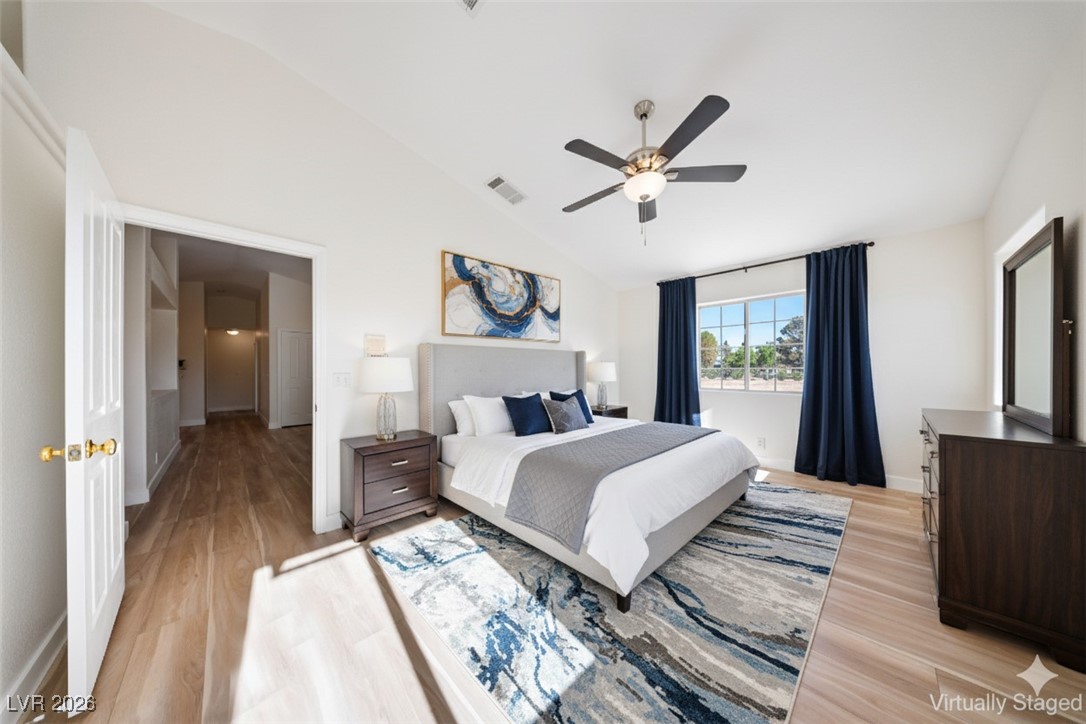 2420 Tough Boy Road Pahrump, NV 89060 - Photo 16 of 54 Bedroom featuring light wood finished floors, ceiling fan, and high vaulted ceiling
