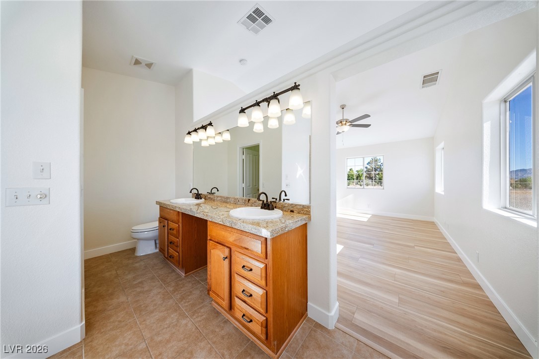 2420 Tough Boy Road Pahrump, NV 89060 - Photo 20 of 54 Full bathroom with double vanity, ceiling fan, and tile patterned flooring