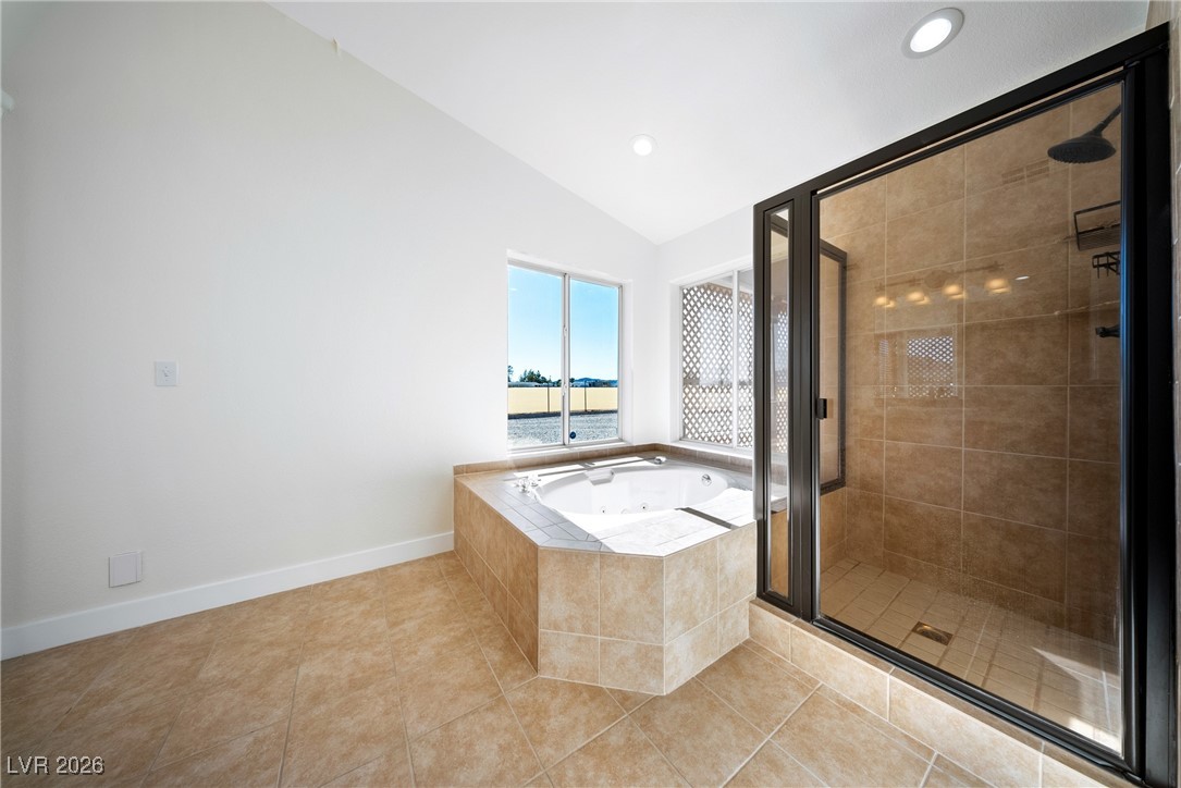 2420 Tough Boy Road Pahrump, NV 89060 - Photo 21 of 54 Full bath with a stall shower, a whirlpool tub, vaulted ceiling, tile patterned flooring, and recessed lighting