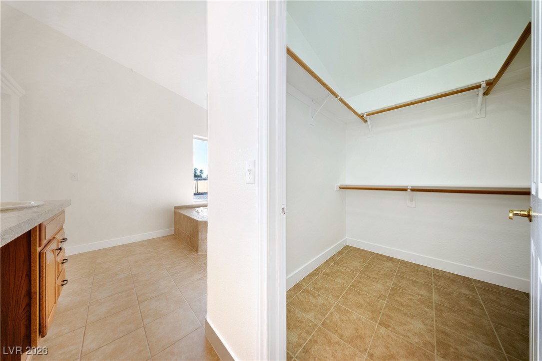 2420 Tough Boy Road Pahrump, NV 89060 - Photo 23 of 54 Spacious closet with light tile patterned floors and vaulted ceiling