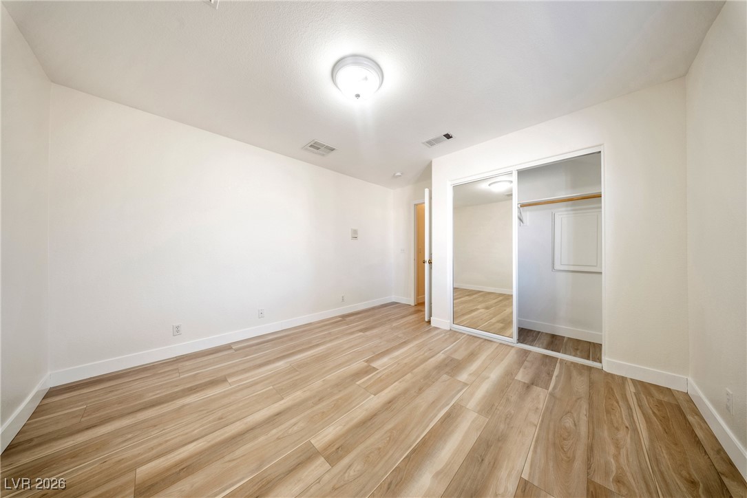 2420 Tough Boy Road Pahrump, NV 89060 - Photo 27 of 54 Unfurnished bedroom with light wood-style floors and a closet