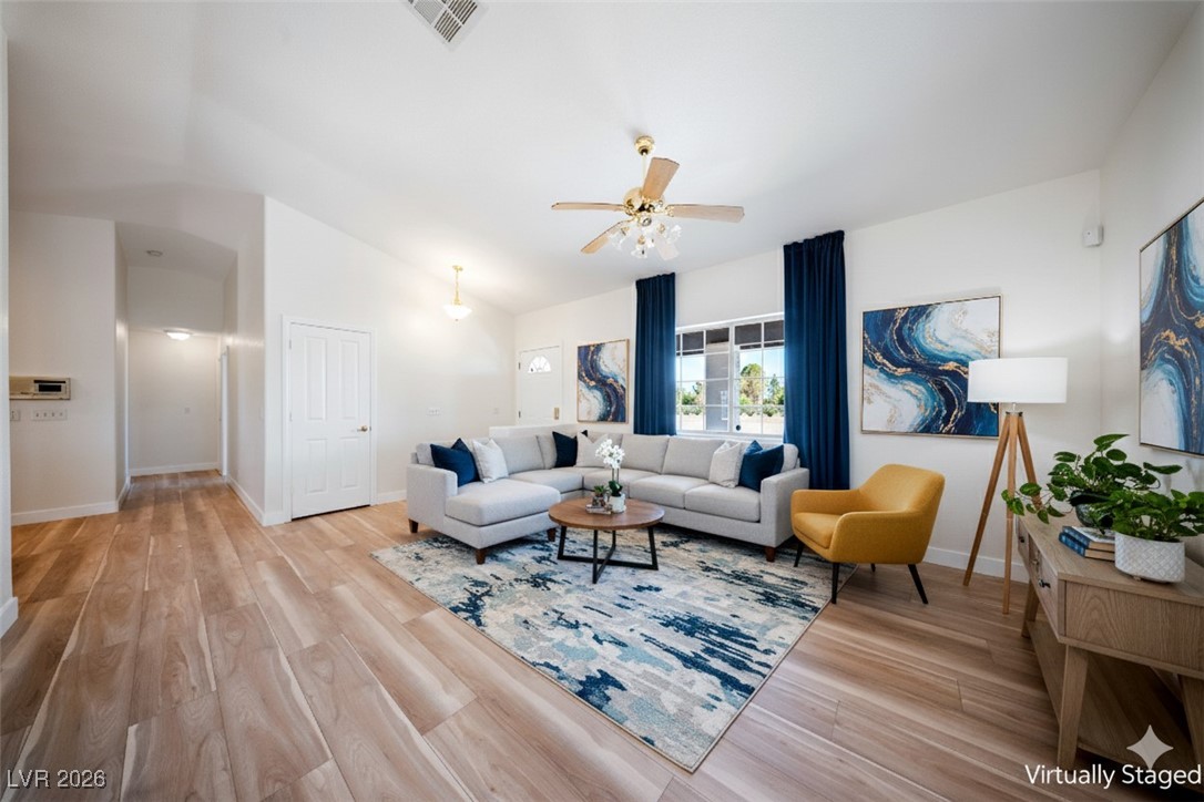 2420 Tough Boy Road Pahrump, NV 89060 - Photo 4 of 54 Living area featuring vaulted ceiling, light wood-style flooring, and a ceiling fan