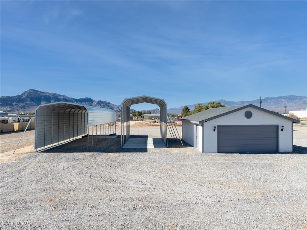 2420 Tough Boy Road Pahrump, NV 89060 - Photo 41 of 54 Detached garage featuring a mountain view and a carport