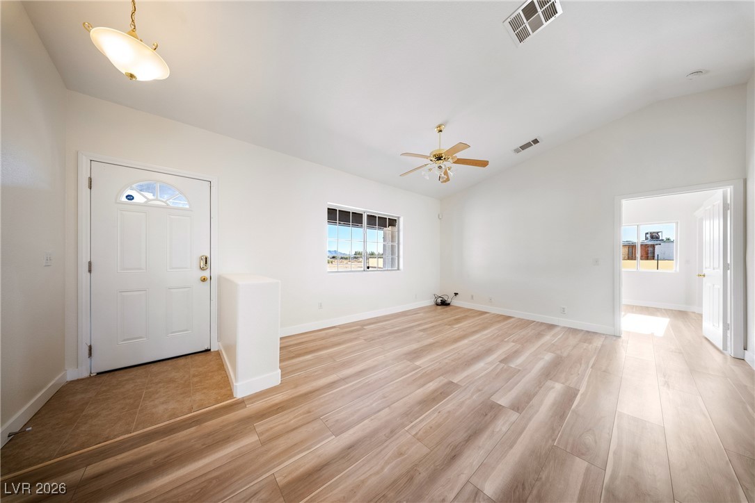 2420 Tough Boy Road Pahrump, NV 89060 - Photo 6 of 54 Foyer entrance featuring lofted ceiling, a ceiling fan, and light wood-type flooring