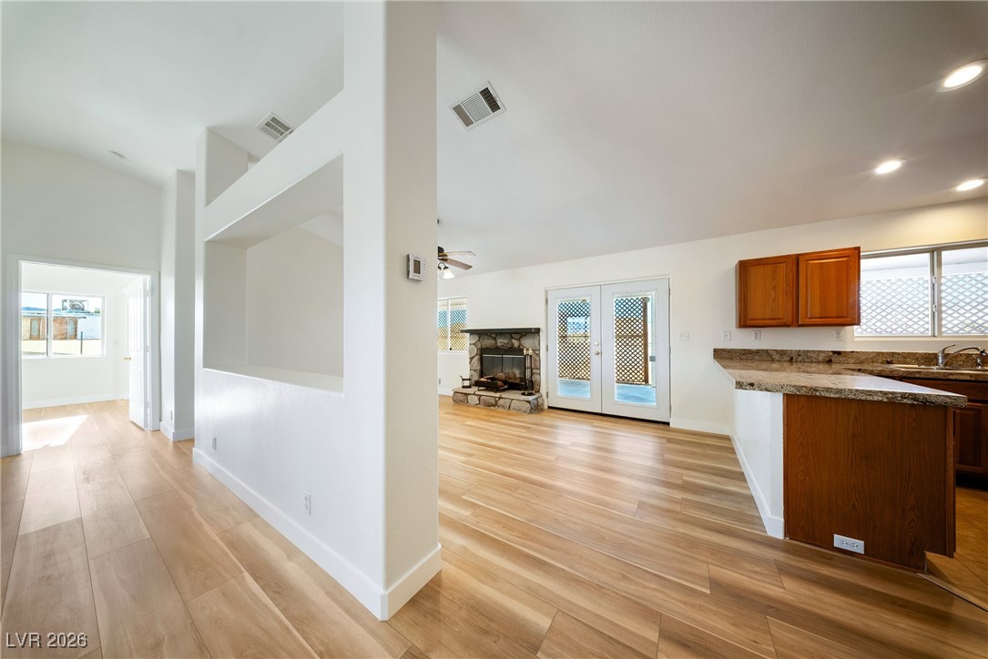 2420 Tough Boy Road Pahrump, NV 89060 - Photo 53 of 54 Kitchen with a fireplace, lofted ceiling, open floor plan, light wood finished floors, and plenty of natural light