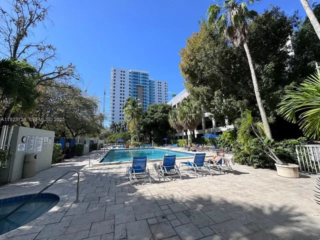 a view of backyard with a table and chairs and potted plants