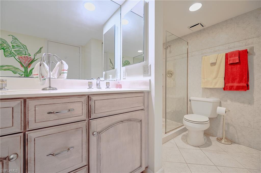 1100 9th Street South, Unit E101 Naples, FL 34102 - Photo 13 of 35 a bathroom with a toilet sink and mirror