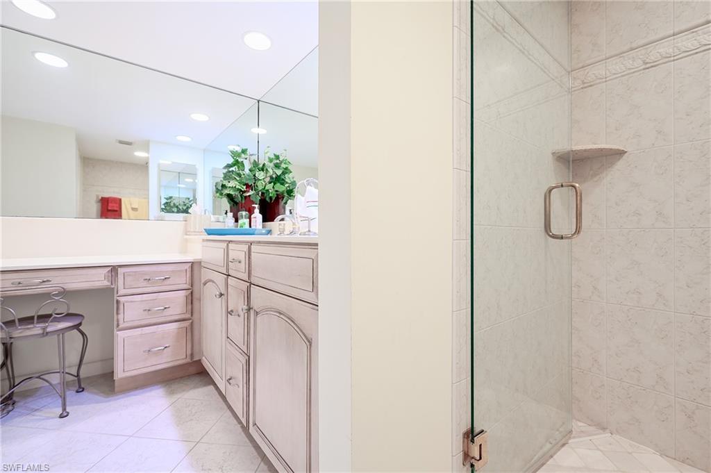 1100 9th Street South, Unit E101 Naples, FL 34102 - Photo 14 of 35 a utility room with cabinets washer and dryer