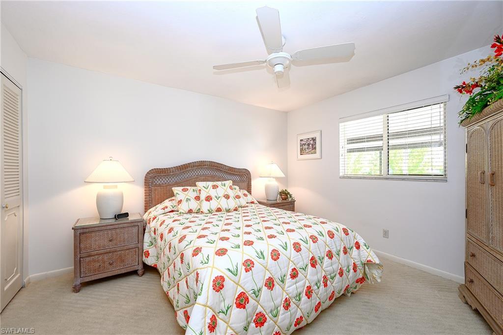 1100 9th Street South, Unit E101 Naples, FL 34102 - Photo 15 of 35 a bedroom with a bed and a window