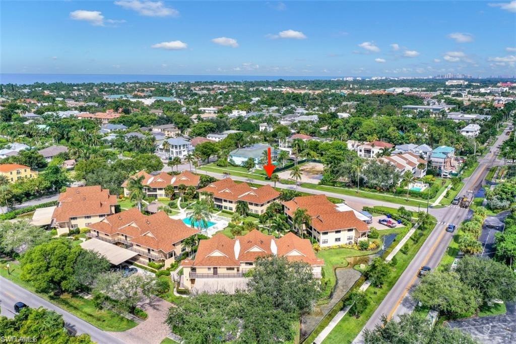 1100 9th Street South, Unit E101 Naples, FL 34102 - Photo 20 of 35 an aerial view of residential houses with outdoor space and trees