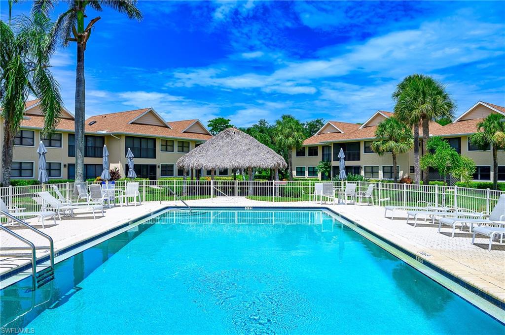1100 9th Street South, Unit E101 Naples, FL 34102 - Photo 21 of 35 a view of a house with swimming pool and sitting area