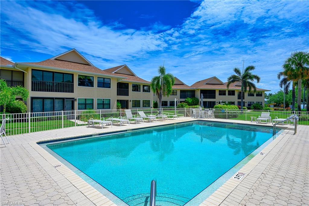 1100 9th Street South, Unit E101 Naples, FL 34102 - Photo 22 of 35 a view of house with a swimming pool