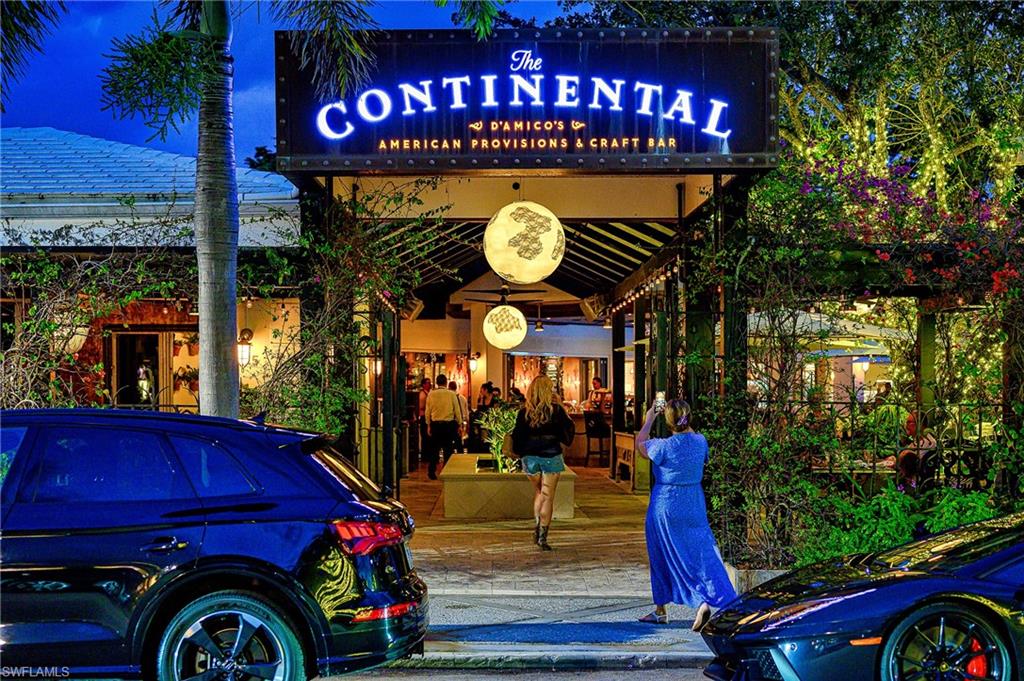 1100 9th Street South, Unit E101 Naples, FL 34102 - Photo 25 of 35 a view of a red car park in front of a house