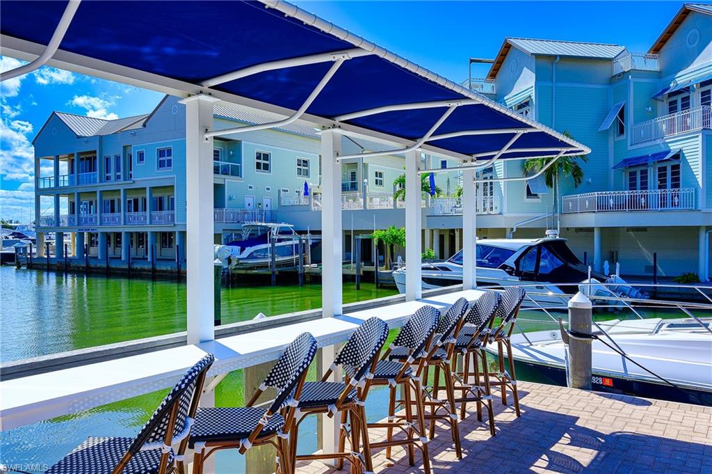 1100 9th Street South, Unit E101 Naples, FL 34102 - Photo 26 of 35 a view of a dining room with furniture window and outside view