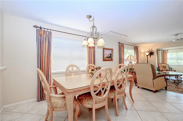 a view of a dining room with furniture and chandelier