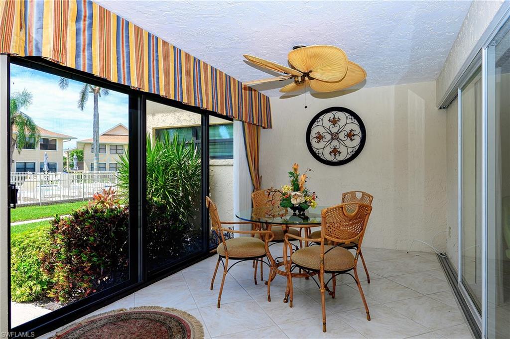 1100 9th Street South, Unit E101 Naples, FL 34102 - Photo 9 of 35 a view of a chairs and table in a balcony