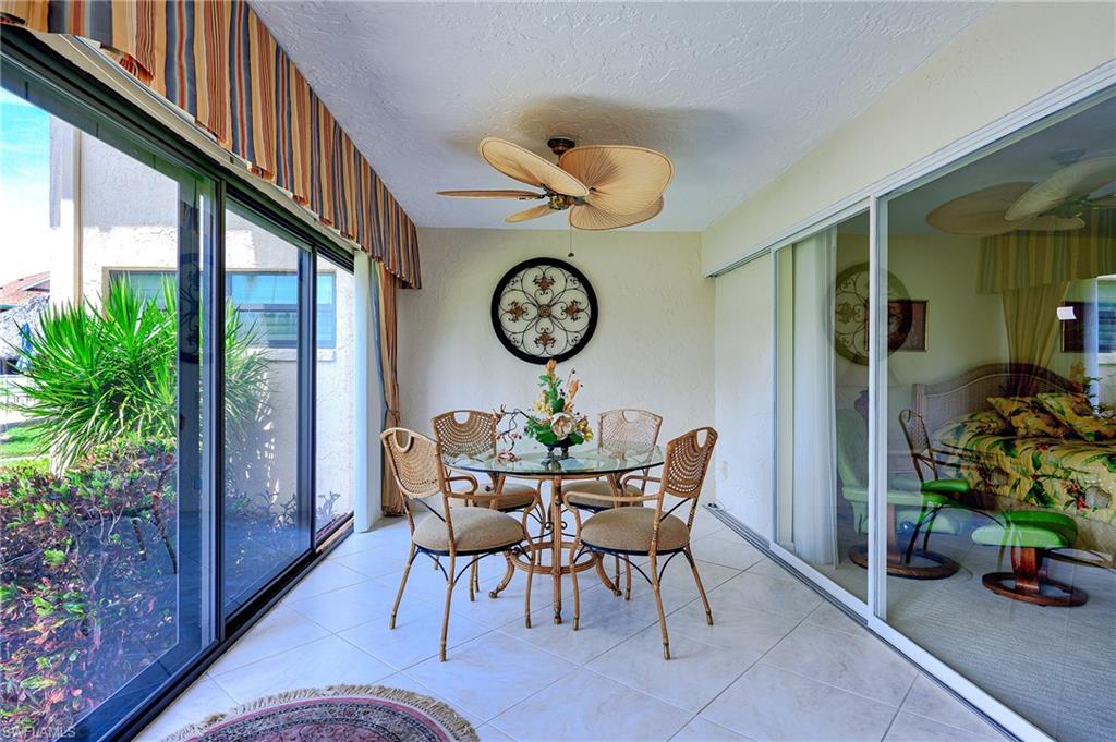 1100 9th Street South, Unit E101 Naples, FL 34102 - Photo 10 of 35 a view of a dining room with furniture window and wooden floor