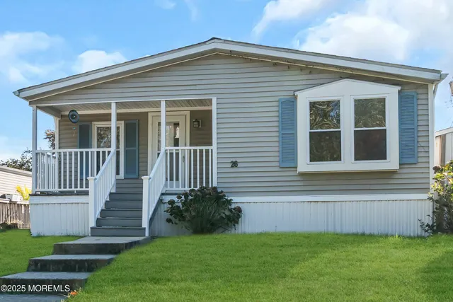 a view of a house with a yard and a garden