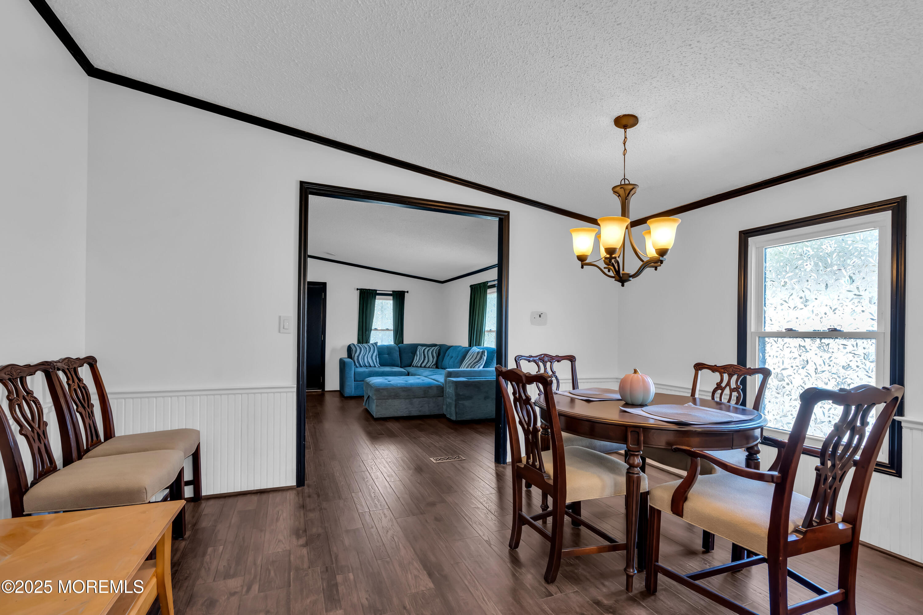 1820 Highway 35, Unit HOME SITE #26 Wall, NJ 07719 - Photo 13 of 35 a view of a dining room with furniture wooden floor and chandelier