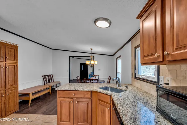 a kitchen with sink refrigerator and stove