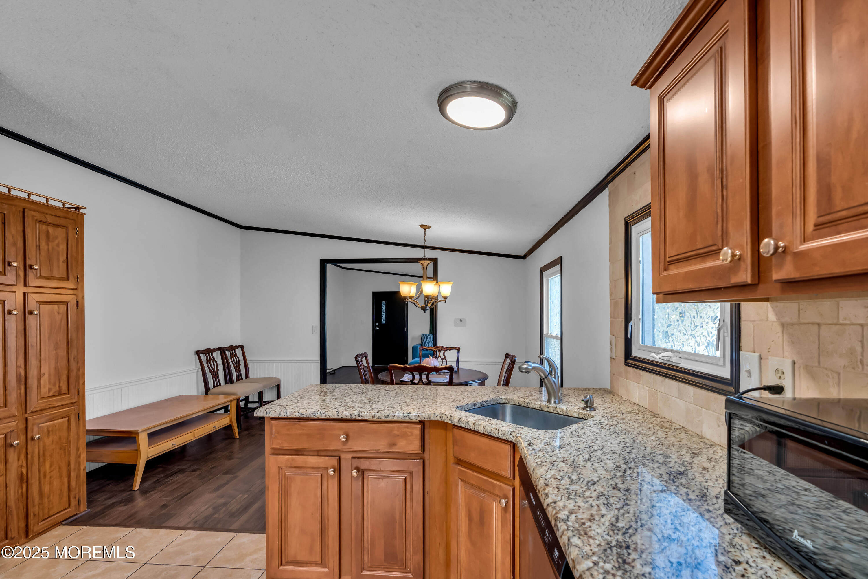 1820 Highway 35, Unit HOME SITE #26 Wall, NJ 07719 - Photo 18 of 35 a kitchen with sink refrigerator and stove