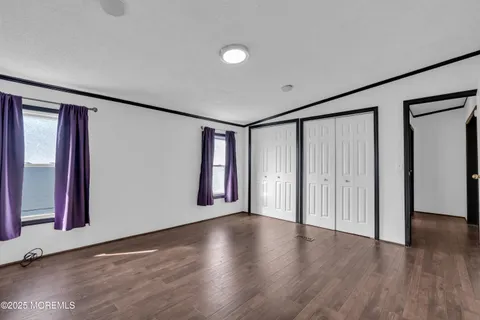 a view of a livingroom with wooden floor and window