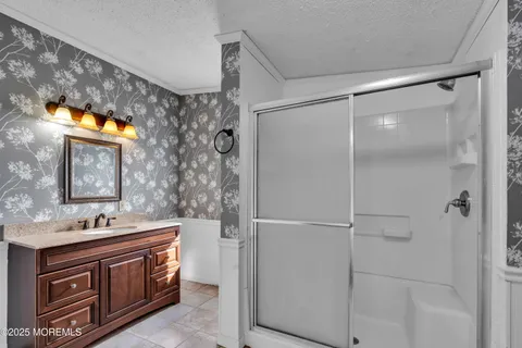 a bathroom with a sink vanity and a mirror