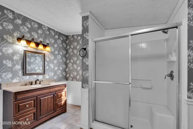 a bathroom with a sink vanity and a mirror