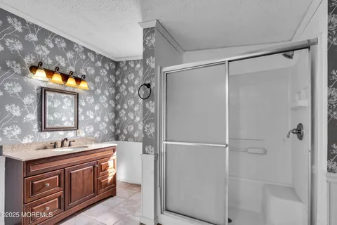 a bathroom with a sink vanity and a mirror