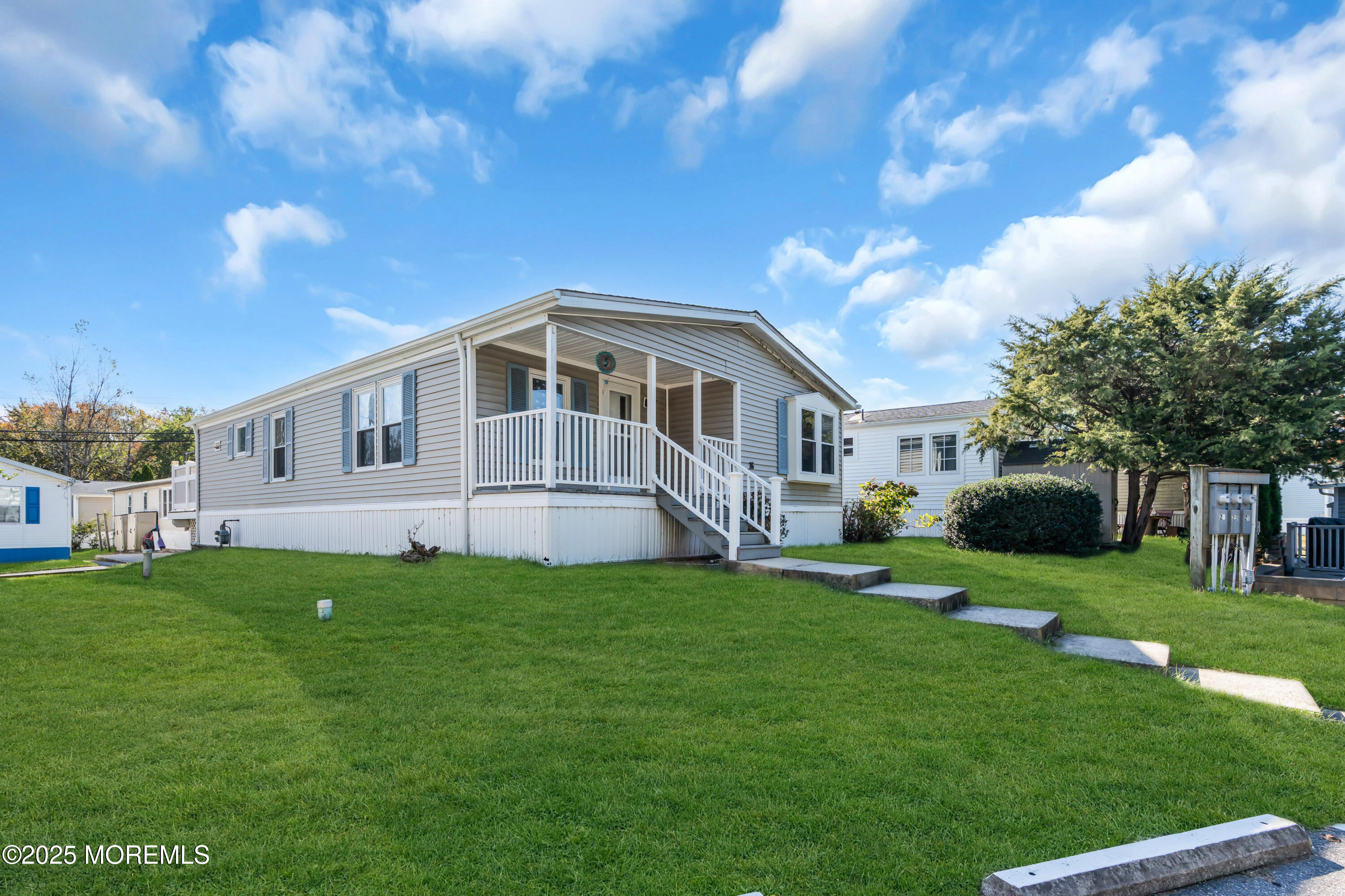 1820 Highway 35, Unit HOME SITE #26 Wall, NJ 07719 - Photo 3 of 35 a front view of a house with a garden