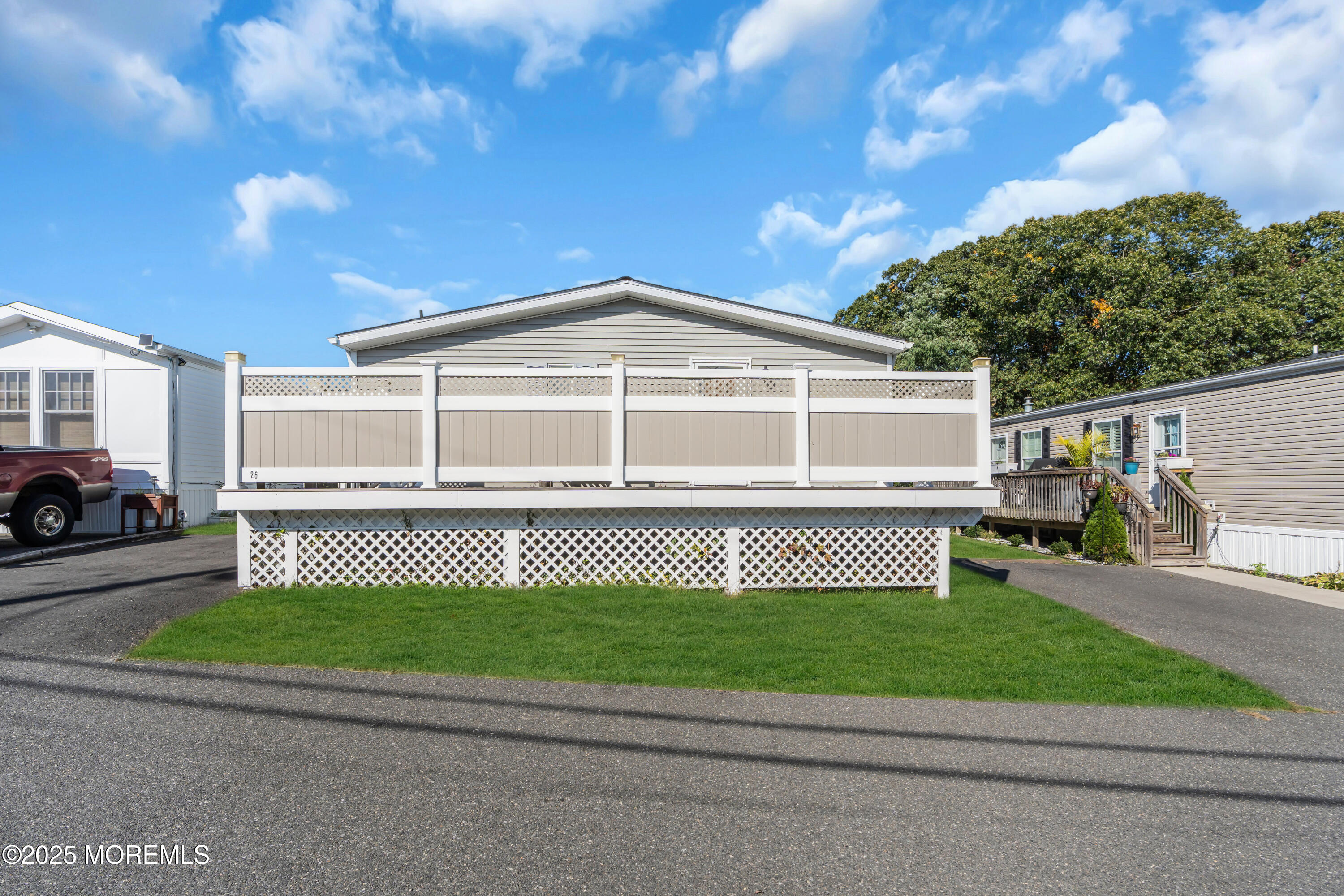 1820 Highway 35, Unit HOME SITE #26 Wall, NJ 07719 - Photo 34 of 35 a front view of a house with a garden