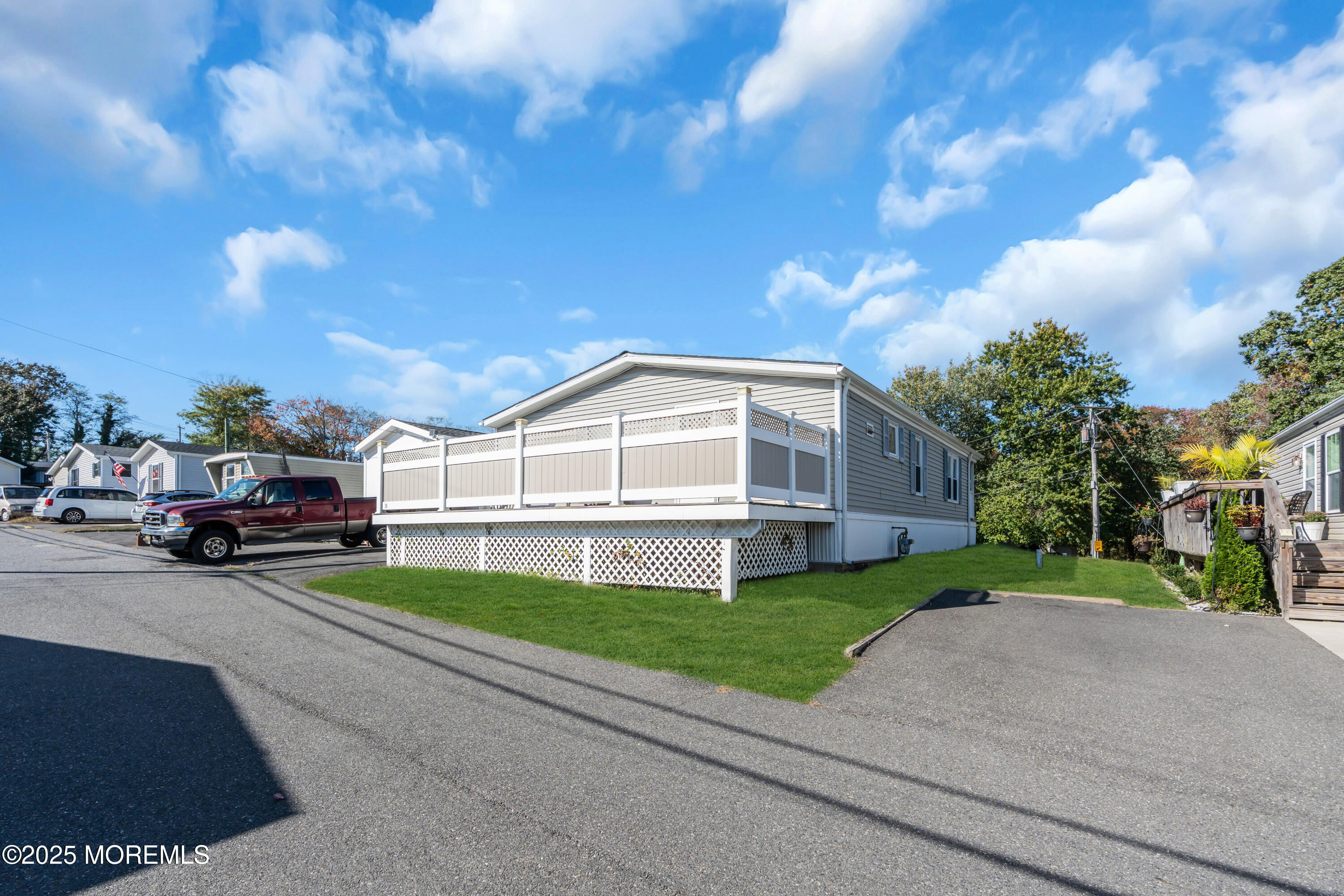 1820 Highway 35, Unit HOME SITE #26 Wall, NJ 07719 - Photo 35 of 35 a view of a white house with a big yard and large trees