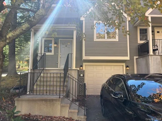 a front view of a house with parking area